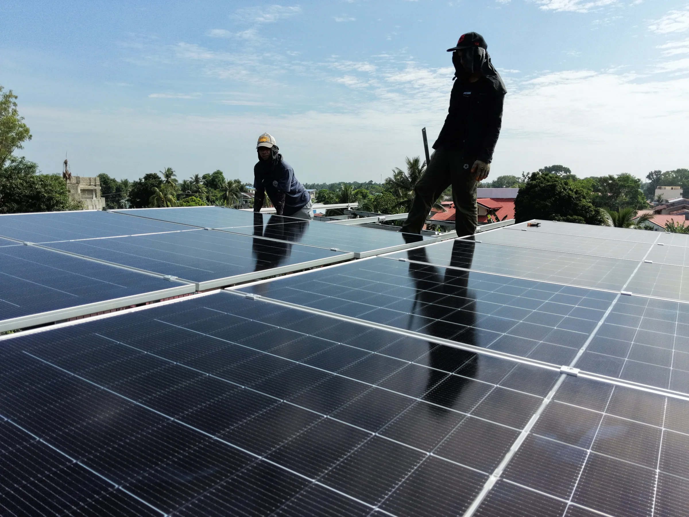 Daet Solar installers working on a 6 kW rooftop solar system in Vinzons, Camarines Norte