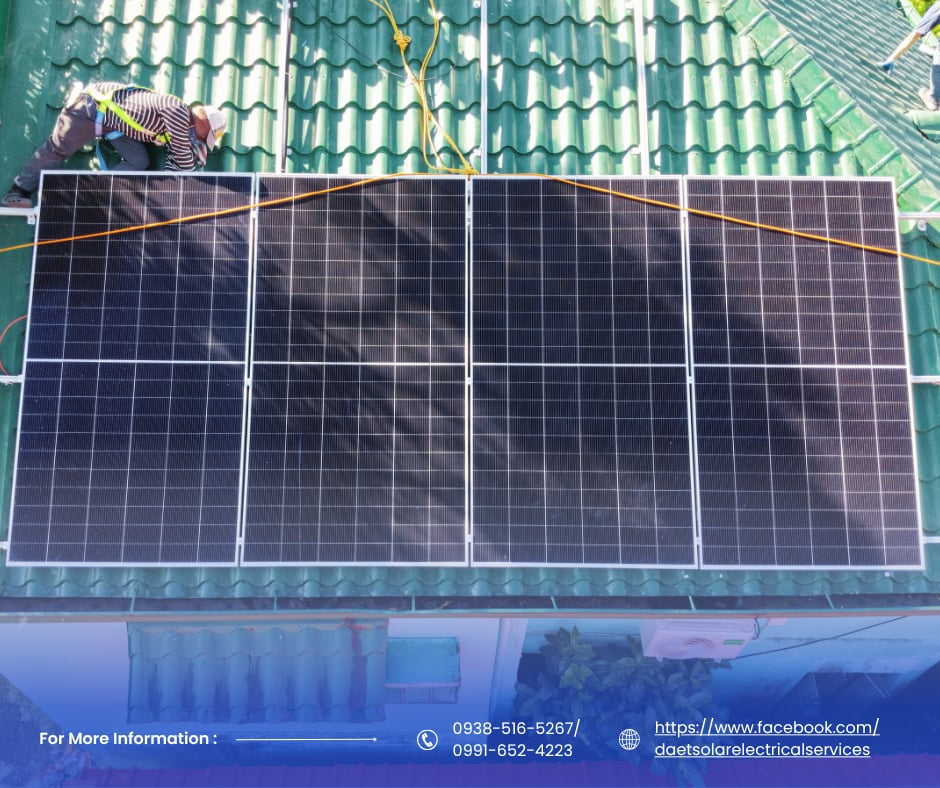 Four solar panels installed on a green residential roof